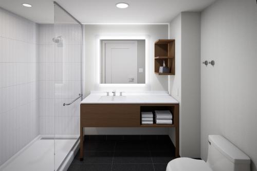 刘易斯Staybridge Suites Rehoboth Beach, an IHG Hotel的一间带水槽和淋浴的浴室