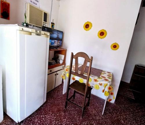 巴拉瓜里Jasy Hospedaje的厨房配有椅子和白色冰箱