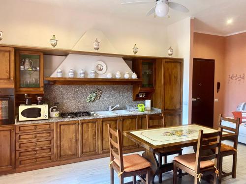 梅尔卡特勒瓦尔迪佩萨Barbara's apartment的厨房配有木制橱柜和桌椅