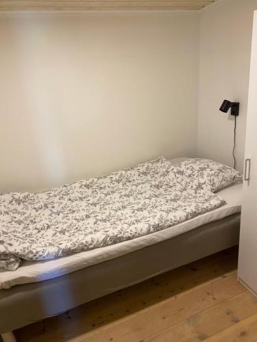 费尔耶斯塔登Idyliska boende mitt på Öland的一张带床垫的客房内的一张未铺好的床