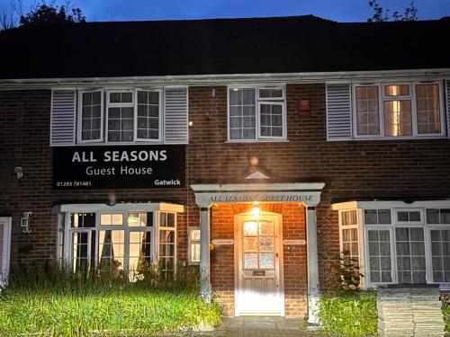 霍利All Seasons Gatwick Guest House & Parking的砖砌的建筑,旅馆前门