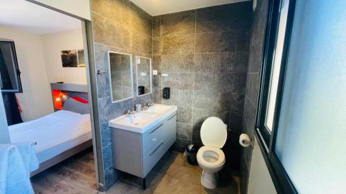 锡拉奥La Villa Kazuera的一间带水槽、卫生间和淋浴的浴室