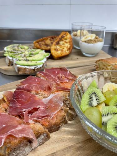 格罗韦HOTEL BOUTIQUE VILAVELLA的一张桌子,上面放着一大堆不同种类的面包和水果