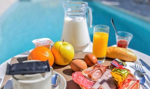 DjerbaDIAR HAROUN的一张桌子,早餐包括鸡蛋水果和牛奶