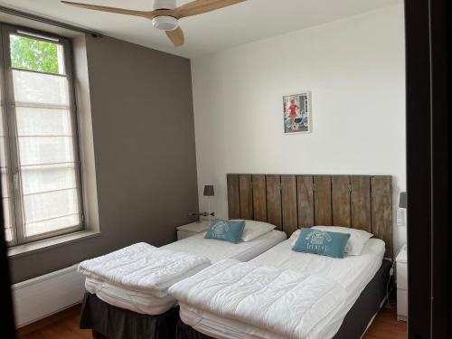 圣马丹德雷Jolie location contemporaine dans Saint Martin de Ré的一间卧室配有一张带蓝色枕头的大床