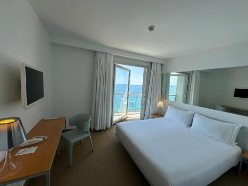 的里雅斯特Hotel Miramare - Adults Only的配有一张床、一张书桌和一扇窗户的酒店客房