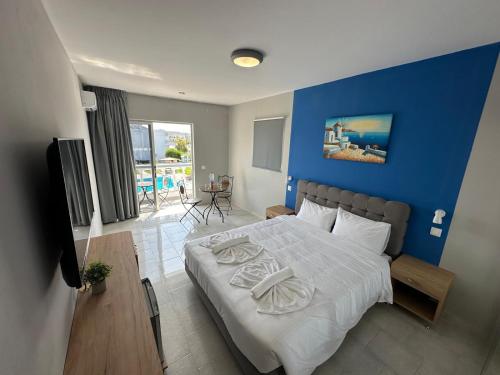 塞奥洛戈斯Ayit Hotel的一间卧室设有一张蓝色墙壁的大床