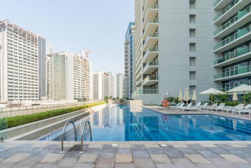 迪拜Delightful 2BR apartment at Reva Residences的一座位于高楼城市的游泳池