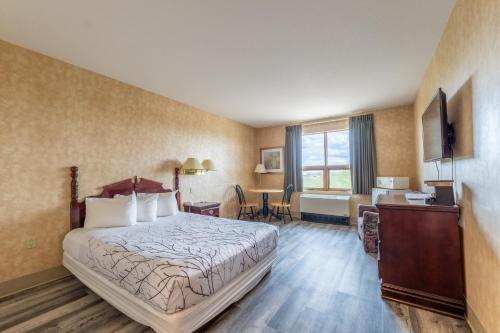 CaronportPilgrim Inn的配有一张床和一张书桌的酒店客房