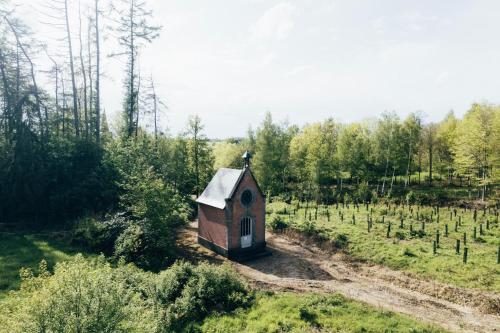 绍蒙－吉斯图Tiny House Au Coeur de la Campagne Wallonne的田间中的小房子