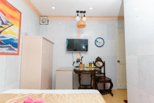 芹苴Motel Hoài An的一间卧室配有一张床、一张桌子和一台电视。