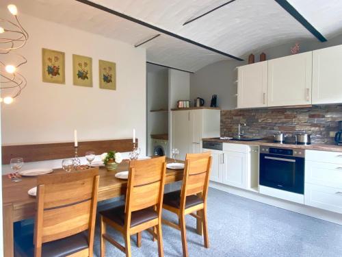 卡劳特格瑞斯赫Ferienhaus "Am Papststein"的厨房配有木制餐桌和椅子