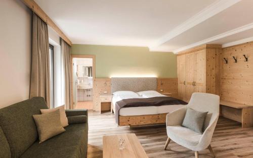 蒂鲁罗卡琳公寓式酒店的一间卧室配有一张床和一个沙发