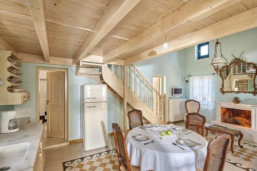 卡米拉日Orelia Cretan Deluxe Apartments的一间带桌子和楼梯的用餐室