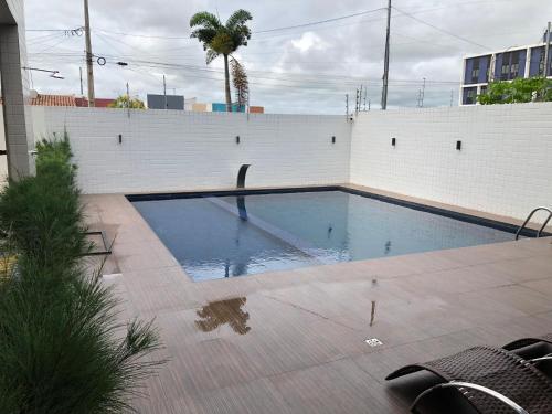 大坎皮纳Apartamento para São João的白色墙壁前的游泳池