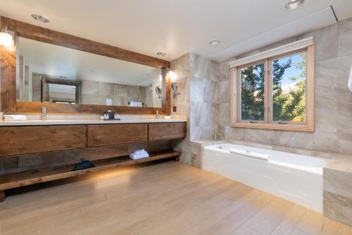 特柳赖德山峰水疗度假酒店的带浴缸、水槽和镜子的浴室