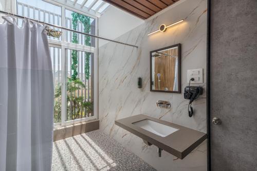 伊加特普里Wabi Sabi Resort, Igatpuri的一间带水槽和窗户的浴室