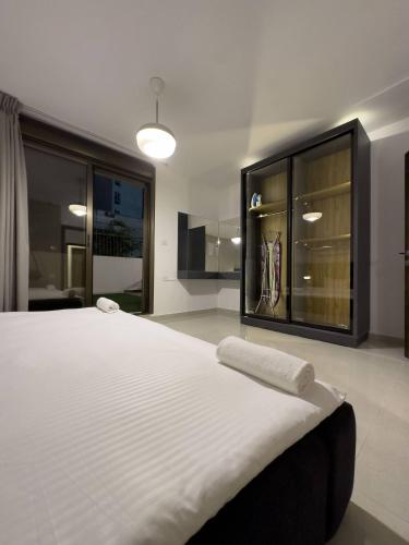 安曼Stylish Luxe Apartment的卧室配有一张大白色床和衣柜