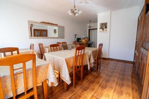 Caldas de São JorgeCasa do Campo AL的用餐室配有2张桌子和木椅