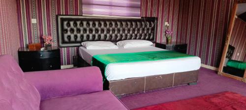 DisahEuropean luxury camp的一间卧室配有一张床、一把椅子和一张沙发