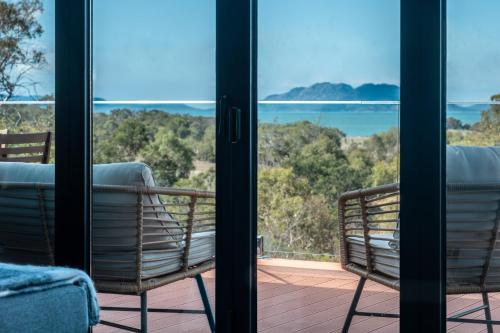 斯旺西Searene - Freycinet Holiday Houses的阳台配有两把椅子,享有海景。