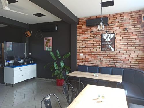 波兹南Pokoje nad pizzerią的一间带桌椅的餐厅以及砖墙