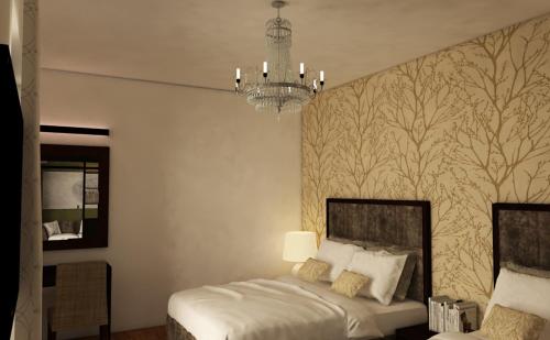 科伦坡TeaTalk的一间卧室配有一张床和一个吊灯