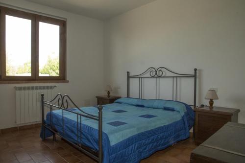 福洛尼卡Agriturismo Sant'Orsola的一间卧室配有一张带蓝色棉被的床