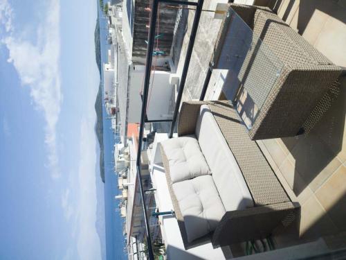 尼亚普拉莫斯SEAgull apartments的大楼内带白色椅子的阳台的顶部景色