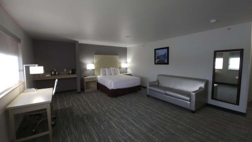 西瓦利城Best Western West Valley Inn的配有一张床和一把椅子的酒店客房