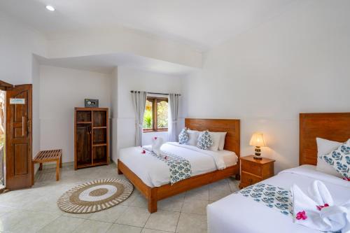 蓝梦岛努沙英达别墅酒店的一间卧室设有两张床和窗户。