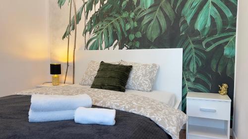 卡托维兹Parkcity Katowice Bogucice的一间卧室配有一张带热带壁纸的床