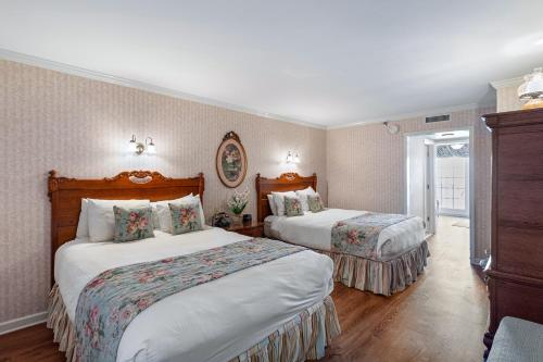 柏斯海滩Boardwalk Plaza Hotel的配有两张床的酒店客房中的两张床