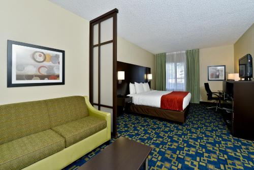 奥兰多Comfort Inn & Suites Near Universal Orlando Resort-Convention Ctr的酒店客房,配有床和沙发