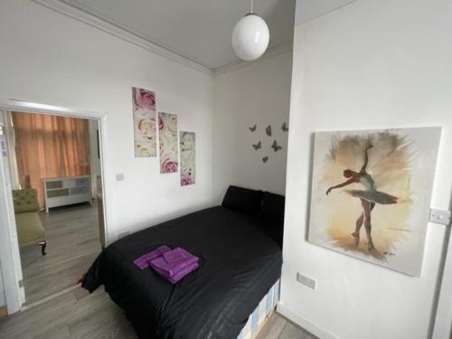 伦敦RSB Inn London的卧室配有一张床,墙上挂有绘画作品