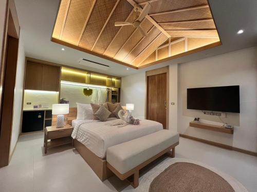 卡农Luxtalay khanom Hotel的一间卧室配有一张床和一台平面电视