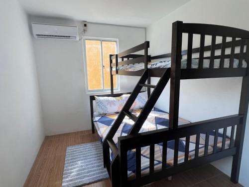 Affordable 2 storey transient house with free wifi in Camella Homes Koronadal的带窗户的客房内的两张双层床