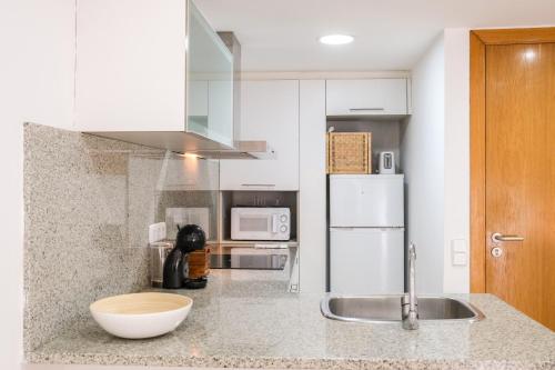 贝萨卢Ca lEudald 2 Ideal para parejas con terraza的厨房配有水槽和白色冰箱