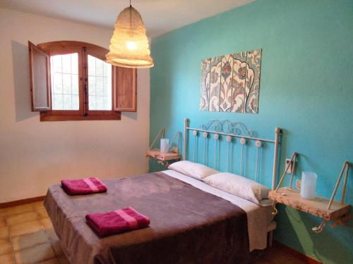 拉斯内格拉斯卡萨斯诺里拉乡村民宿的一间卧室配有一张带两个红色毛巾的床