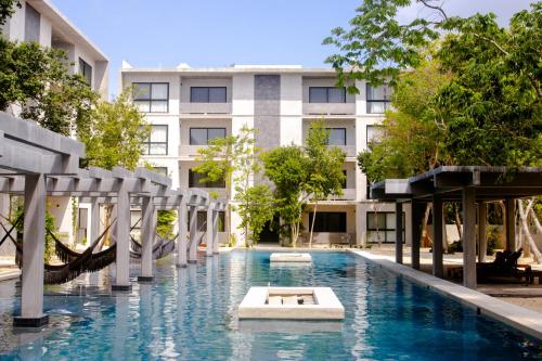 图卢姆Hotel Casa Tortuga Tulum - Cenotes Park Inclusive的大楼前的游泳池