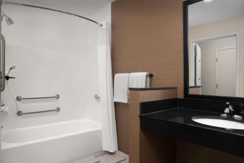 苏福尔斯费尔菲尔德客栈及套房万豪苏福尔斯机场酒店的一间带水槽、浴缸和镜子的浴室