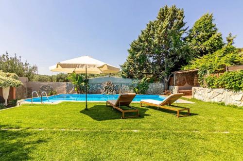 FoinikiáDM Elegant and Charming Villa的一个带两把椅子和一把遮阳伞的庭院和一个游泳池