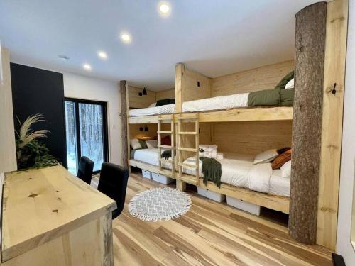 圣弗朗索瓦小河ONИEA l Sauna & Spa的客房设有两张双层床和一张书桌。