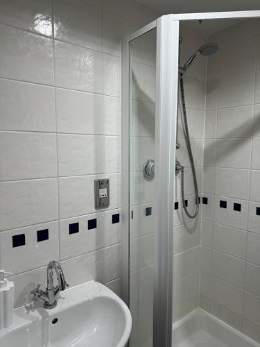 切姆Luxurious 3 Bedroom Penthouse in City Centre - Sleeps 8!的带淋浴和盥洗盆的白色浴室