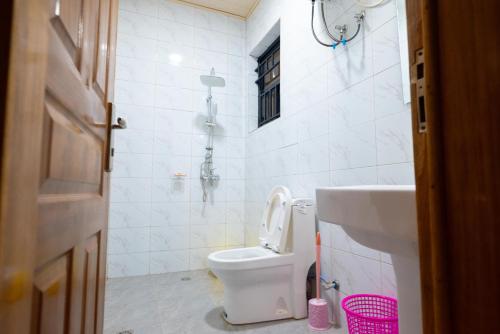 基加利Venus VIP VILLA SUITES的白色的浴室设有卫生间和水槽。