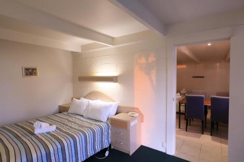 莱克斯恩特伦斯Ocean Views Motel Lakes Entrance的酒店客房 - 带一张床和用餐室