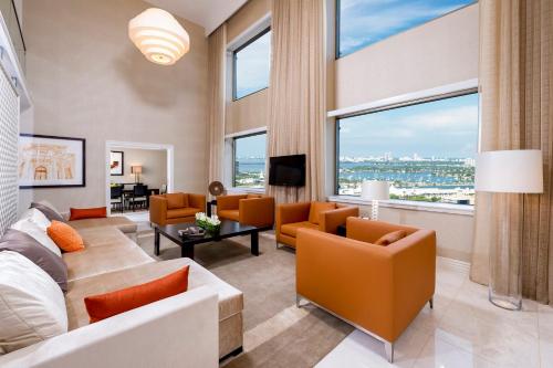 迈阿密迈阿密洲际酒店的客厅配有橙色家具和大窗户