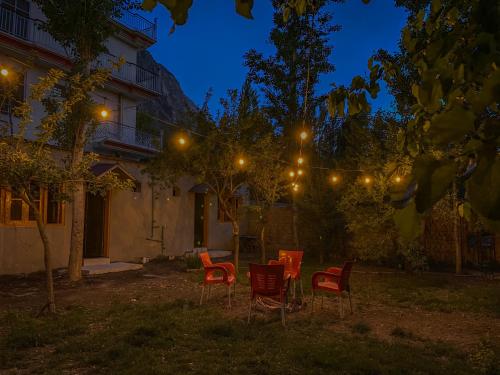 锡卡都Biafo House的一群椅子和灯在院子里晚上