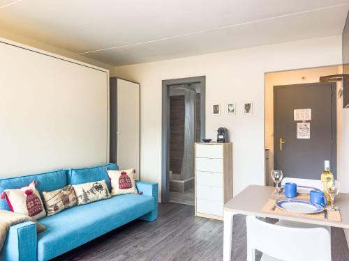 西维耶兹Apartment Rosablanche C12 by Interhome的客厅配有蓝色的沙发和桌子