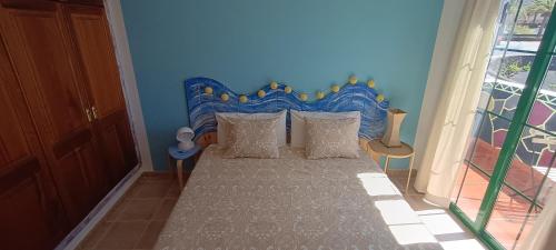 亚伊萨Casa Luz的一间卧室配有一张蓝色床头板的床